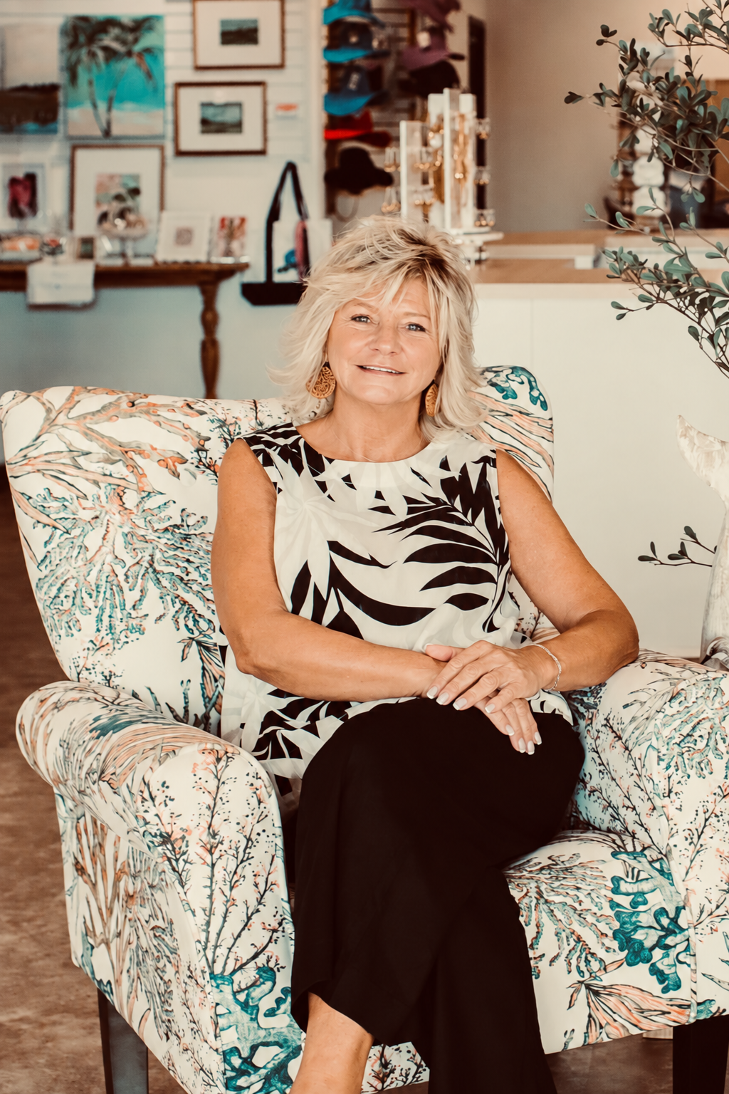 Joan Pacifico, owner and founder of Sandalwood Shoppes, seated in the store